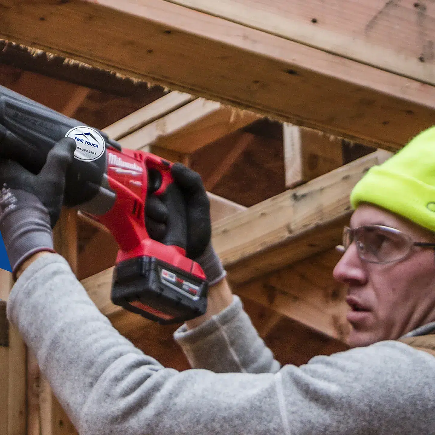Construction worker using a drill on a framing job