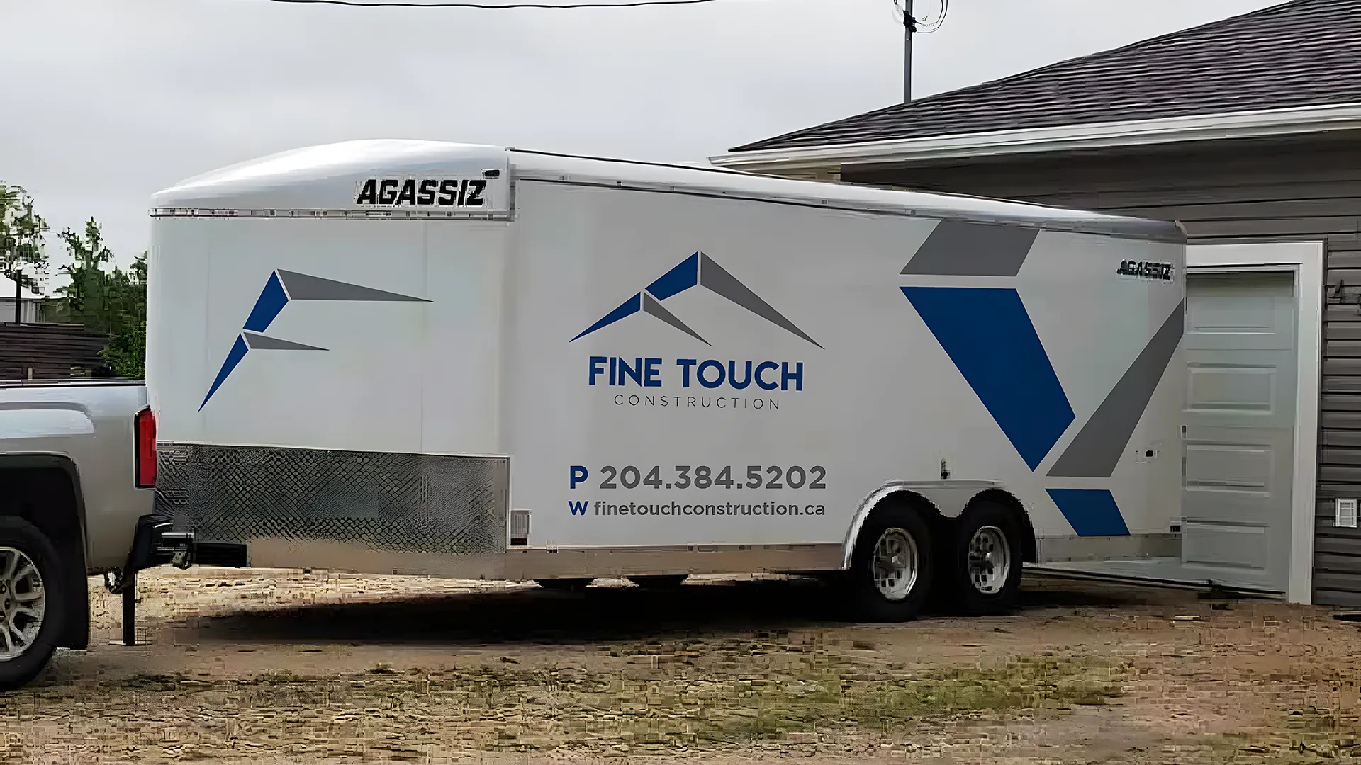 Fine Touch Construction branded work truck and trailer