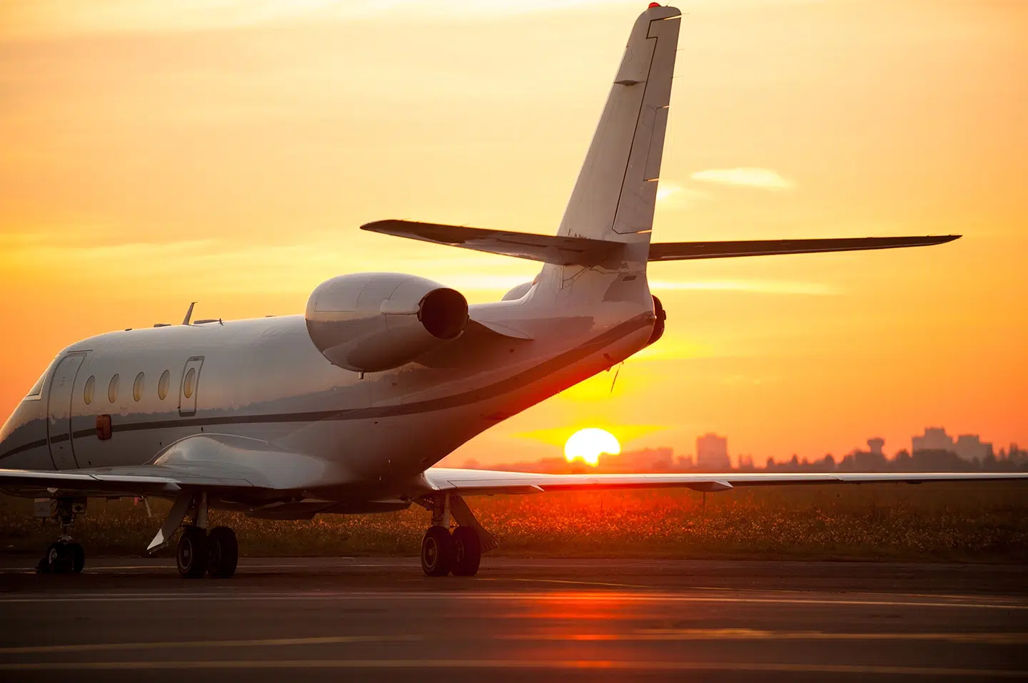 Avion private jet on the tarmac at sunset