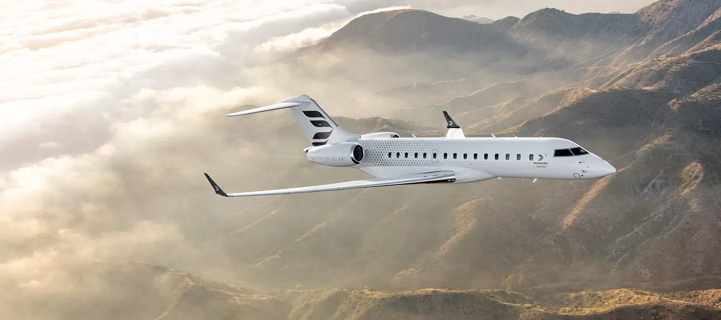 Avion private jet flying over mountains