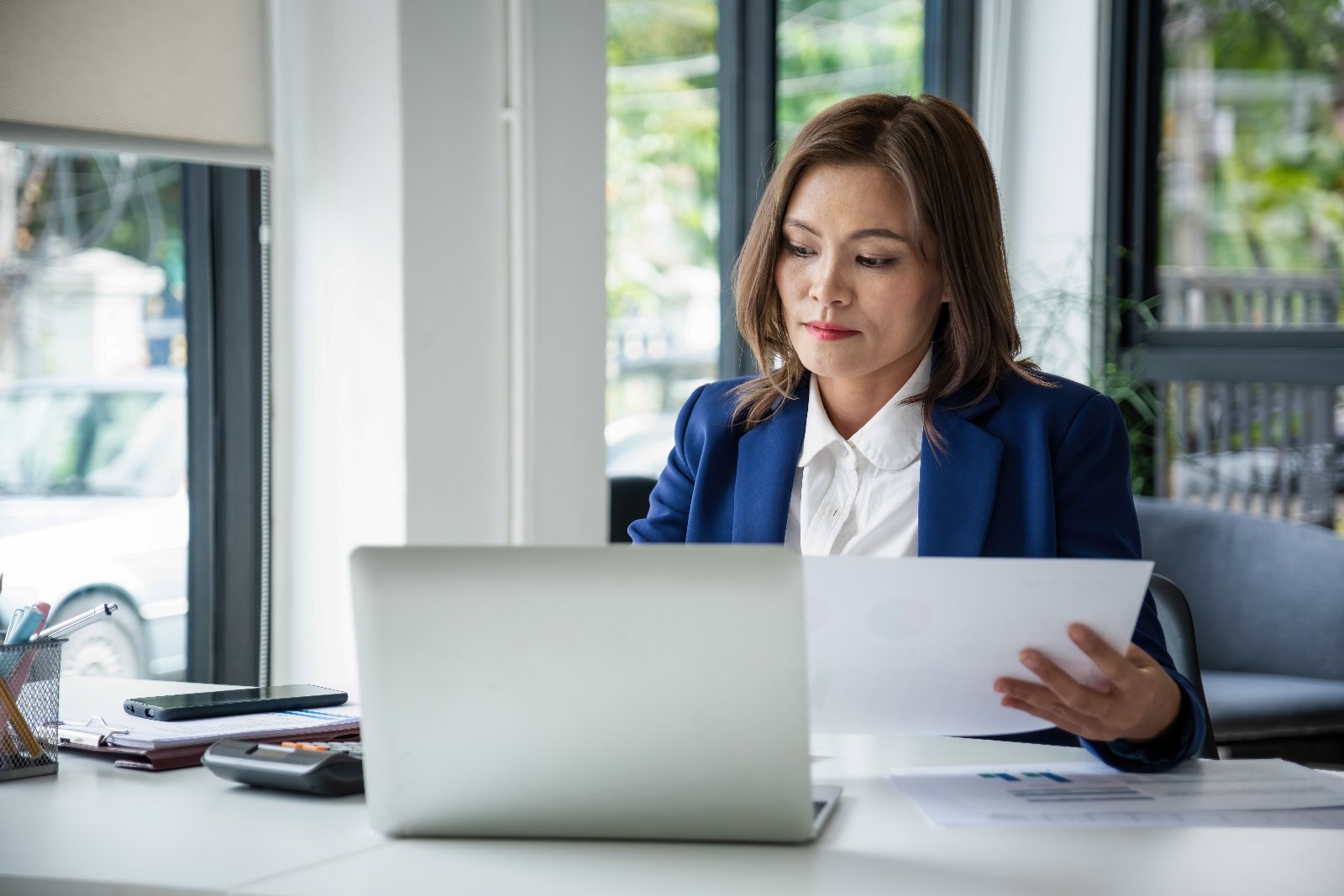 Businesswoman reviewing analytics dashboard representing an AI trust and conversion audit